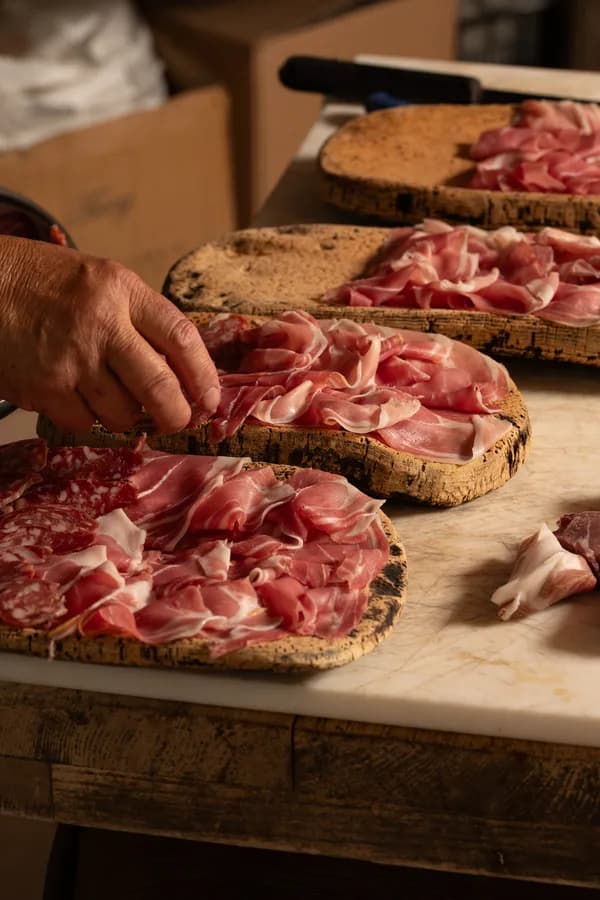 Gallura cured meats sliced by hand and laid out on cork boards